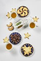 Iftar foods on white table. Traditional middle-eastern lunch with cookies and sweets photo