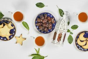 Iftar foods on white table. Traditional middle-eastern lunch with cookies and sweets photo