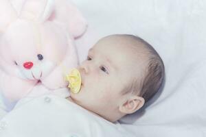 Cute newborn baby boy with easter pink easter bunny photo