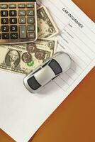 car insurance concept. Blank insurance with toy car and calculator photo