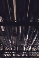 Equipment and piping inside of industrial plant. Factory. Various mechanisms and metal pipes. Toned image. photo