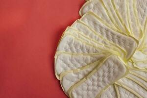 Stack of of feminine hygiene or menstrual pads on red background. Sanitary napkins for women photo