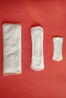 Feminine hygiene pads on red background photo