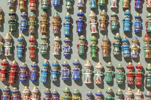 Bukhara, Uzbekistan - March 13, 2019 Colourful handmade ceramic figures selling at street shop in Bukhara, Uzbekistan photo