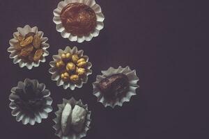 Eid Mubarak. Different iftar sweets. Celebrating Eid Al Adha. Islamic traditional holiday. Eid al-Fitr. Holly month Ramadan. Middle Eastern religious holiday. Dried date fruit. Flat lay, top view. photo