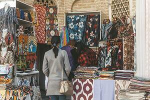 Bukhara, Uzbekistan - March 13, 2019 Outdoor street shops inside of Nadir Divan-Begi Madrasah photo