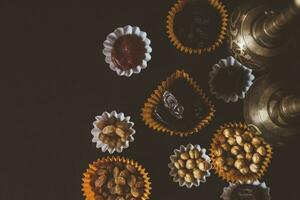 Eid Mubarak. Different iftar sweets. Celebrating Eid Al Adha. Islamic traditional holiday. Eid al-Fitr. Holly month Ramadan. Middle Eastern religious holiday. Dried date fruit. Flat lay, top view. photo