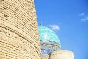 View of the beautiful blue dome of The Mosque Kalyan. One of the oldest and largest Mosque in Central Asia. Main cathedral mosque of Bukhara photo