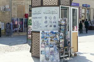 Bukhara, Uzbekistan - March 13, 2019 Kiosk selling greeting cards with photos and views of Bukhara.
