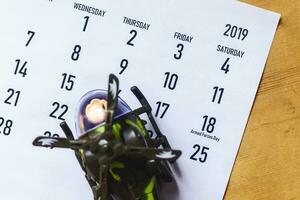 Calendar with toy helicopter as symbol of national armed forces day. 18 May 2019 - Armed Forces Day photo