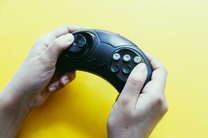 Hand holding game joystick. Gamer playing game photo