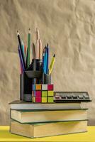 Back to school concept. Stack of books with school supplies photo