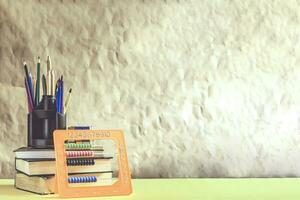 Back to school concept. Stack of books with school supplies photo