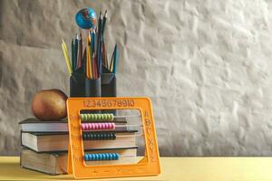 Back to school concept. Stack of books with school supplies photo