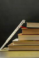 Back to school concept. Stack steps stairs of old books. Toy fire stairs as symbol of growth photo