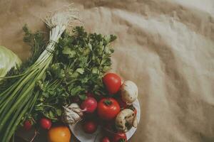 Healthy food background. Assortment of fresh vegetables on paper background photo