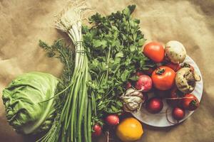 Healthy food background. Assortment of fresh vegetables on paper background photo