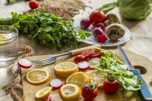 Healthy vegan food background with cutting board and lemon slices. Top view to organic food background with cutting board and lemon slices photo