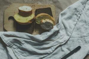 Food concept. Hand cutting bread. Slicing a bread. Top view. photo