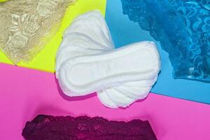 Sanitary pads and female panties. Medicine, women health and ovulation concept. Copy space photo