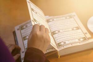 Praying young muslim woman. Middle eastern girl praying and reading the holy Quran. Muslim woman studying The Quran photo