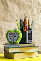 Back to school concept. Stack of books with school supplies photo