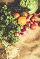 Healthy food background. Assortment of fresh vegetables on paper background photo