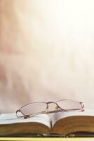 Back to school concept. Glasses on a book. Open book with glasses. photo