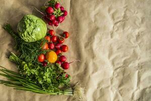 Healthy food background. Assortment of fresh vegetables on paper background photo