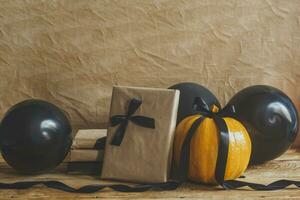 Celebrating Halloween. Orange and black pumpkins with decorated gift box and air balloons photo