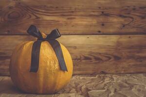 Big Halloween pumpkin decorated with black ribbon photo