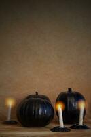 Black halloween pumpkins and candles photo