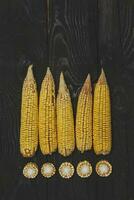 Corns on black wood photo