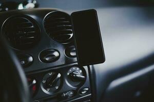 A mobile phone mounted on magnetic car mount photo