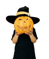 Happy child in Halloween costume holding jack o lantern pumpkin isolated on white photo