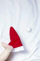 Close-up view of baby boy's legs on red Santa Claus hat. First Christmas of a newborn baby photo