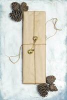 Christmas decorations. Pine cones, Gift box decorated with Christmas tree toys and Pine cones. photo