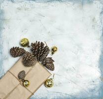 Christmas decorations. Pine cones, Gift box decorated with Christmas tree toys and Pine cones. photo
