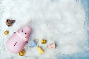 Planning your Christmas budget concept. Christmas toys and piggy bank from above photo