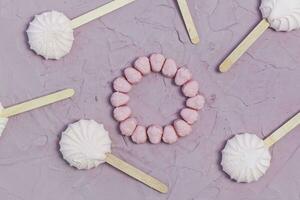 Marshmallows on pink background. Colorful marshmallow sweets with copy space photo