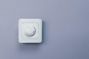 Dimmer Light Switch. A wall switch. Electrician switch. White rolling electricity switch photo