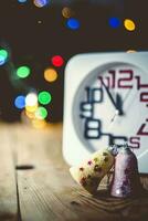 Christmas holiday eve. New year decor with bokeh lights. Magic Winter. Clock at midnight. Greeting new 2020 Year. Clock with blurry magic lights. photo