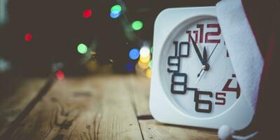 Christmas holiday eve. New year decor with bokeh lights. Magic Winter. Clock at midnight. Greeting new 2020 Year. Clock with blurry magic lights. photo