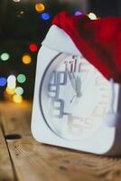 Christmas holiday eve. New year decor with bokeh lights. Magic Winter. Clock at midnight. Greeting new 2020 Year. Clock with blurry magic lights. photo