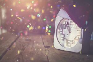 Christmas holiday eve. New year decor with bokeh lights. Magic Winter. Clock at midnight. Greeting new 2020 Year. Clock with blurry magic lights. photo