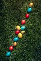 Colorful Easter eggs on the grass photo