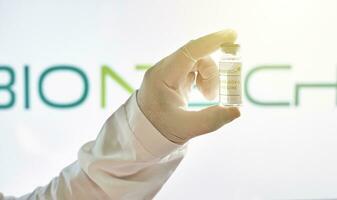 A doctor holds a new vaccine against Covid-19 from German biotechnology company BioNTech photo