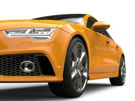 Cadmium yellow modern business car - low angle front view cut shot photo