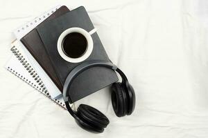 Notepads, earphones and coffee photo