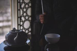 A guy smokes hookah in shisha bar photo